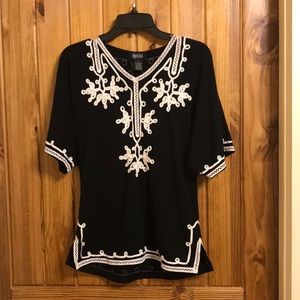 Elegant patterned black top, fits like a medium